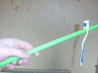 Toothbrush balancing on handstick ready to begin twirling!